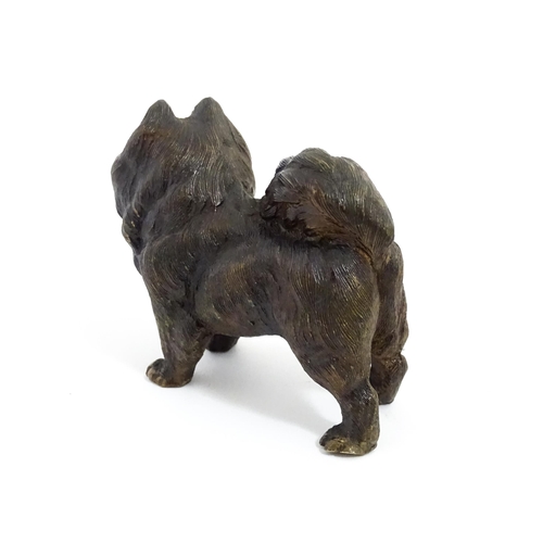 1051 - A 20thC cast bronze model of a dog with red painted eyes. Approx. 2 1/4