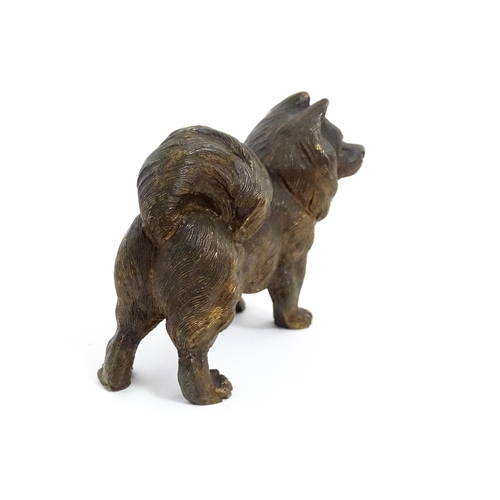 1051 - A 20thC cast bronze model of a dog with red painted eyes. Approx. 2 1/4