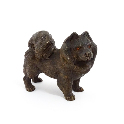 1051 - A 20thC cast bronze model of a dog with red painted eyes. Approx. 2 1/4