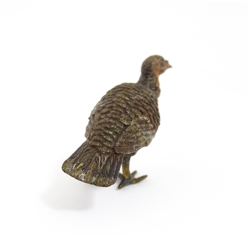 1052 - A cold painted bronze model of a game bird. Approx. 1 3/4