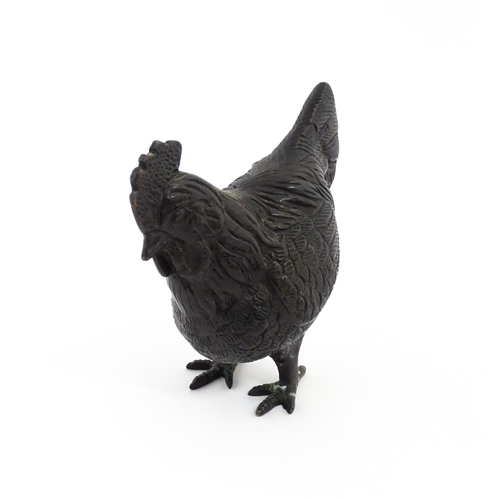 1053 - A 20thC cast model of a cockerel / rooster with feather detail. Approx. 4 3/4