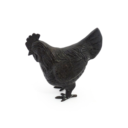 1053 - A 20thC cast model of a cockerel / rooster with feather detail. Approx. 4 3/4