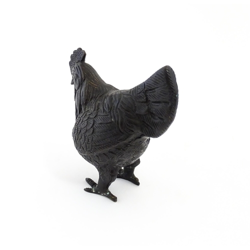 1053 - A 20thC cast model of a cockerel / rooster with feather detail. Approx. 4 3/4