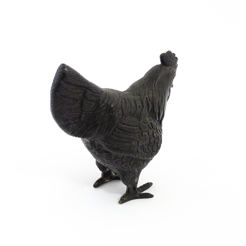 1053 - A 20thC cast model of a cockerel / rooster with feather detail. Approx. 4 3/4