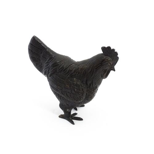 1053 - A 20thC cast model of a cockerel / rooster with feather detail. Approx. 4 3/4