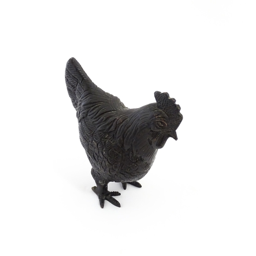 1053 - A 20thC cast model of a cockerel / rooster with feather detail. Approx. 4 3/4