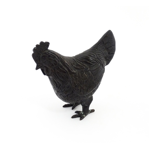 1053 - A 20thC cast model of a cockerel / rooster with feather detail. Approx. 4 3/4