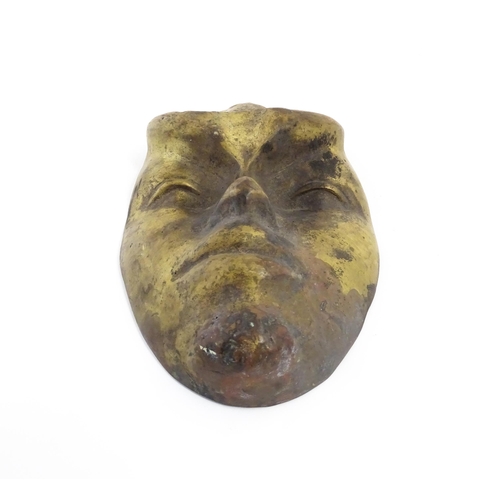 1058 - A 20thC bronze mask / plaque modelled as a face. Approx. 7 1/2