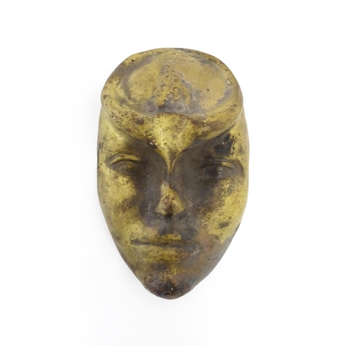 1058 - A 20thC bronze mask / plaque modelled as a face. Approx. 7 1/2