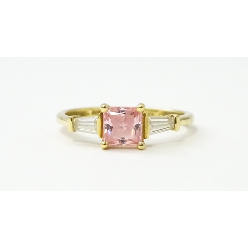 531 - A 14ct gold ring set with central pink stone, flanked by white stones. Ring size approx. S 1/2