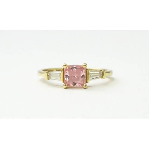 531 - A 14ct gold ring set with central pink stone, flanked by white stones. Ring size approx. S 1/2