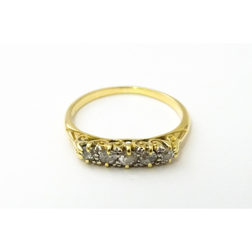 532 - A gold ring set with five graduated diamonds. Ring size approx. L 1/2