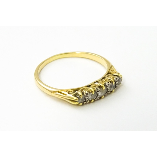 532 - A gold ring set with five graduated diamonds. Ring size approx. L 1/2