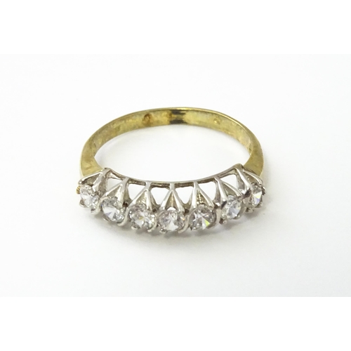 534 - A 9ct gold half eternity ring set with seven white stones. Ring size approx. Q