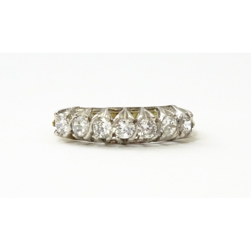 534 - A 9ct gold half eternity ring set with seven white stones. Ring size approx. Q