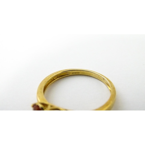 536 - A 9ct gold ring set with hessonite garnet. Ring size approx. N 1/2