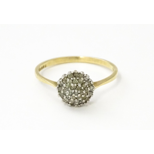 546 - A 9ct gold ring set with diamonds in a cluster setting. Ring size approx. U.