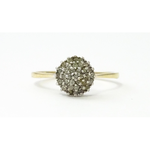 546 - A 9ct gold ring set with diamonds in a cluster setting. Ring size approx. U.