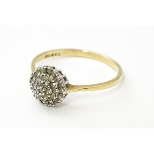 546 - A 9ct gold ring set with diamonds in a cluster setting. Ring size approx. U.