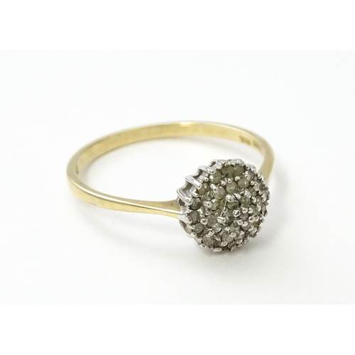 546 - A 9ct gold ring set with diamonds in a cluster setting. Ring size approx. U.