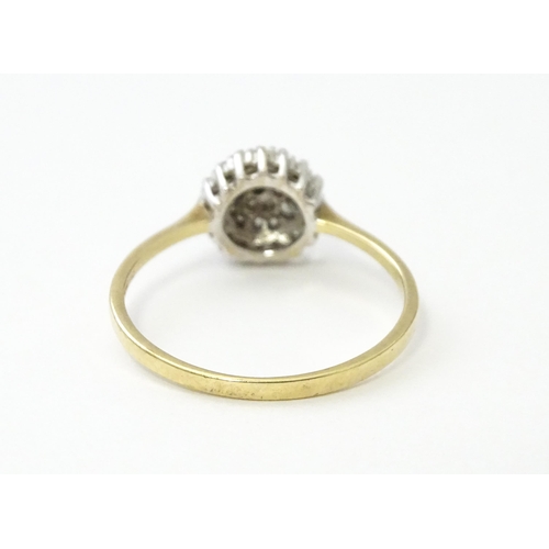 546 - A 9ct gold ring set with diamonds in a cluster setting. Ring size approx. U.