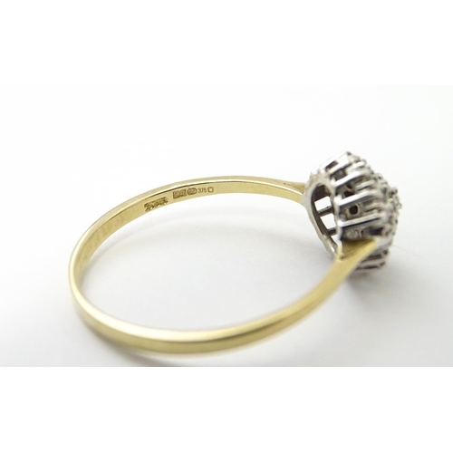 546 - A 9ct gold ring set with diamonds in a cluster setting. Ring size approx. U.