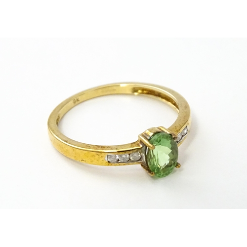 547 - A 9ct gold ring set with central Paraiba tourmaline flanked by diamonds. Ring size approx. N.