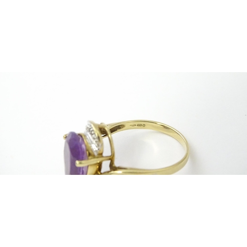 549 - A 9ct gold ring set with central amethyst and diamond. Ring size approx. O 1/2