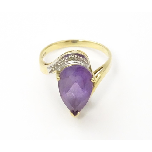 549 - A 9ct gold ring set with central amethyst and diamond. Ring size approx. O 1/2