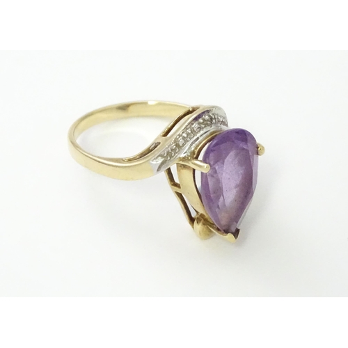 549 - A 9ct gold ring set with central amethyst and diamond. Ring size approx. O 1/2