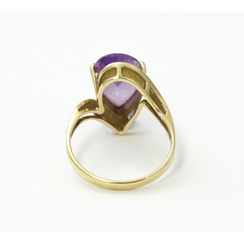 549 - A 9ct gold ring set with central amethyst and diamond. Ring size approx. O 1/2