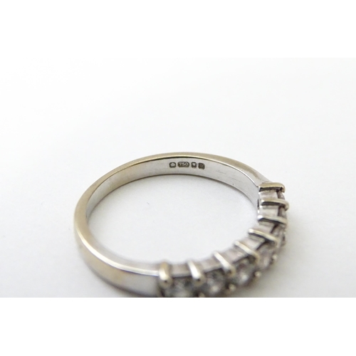 550 - An 18ct white gold half eternity ring set with 7 diamonds. Ring size approx. G