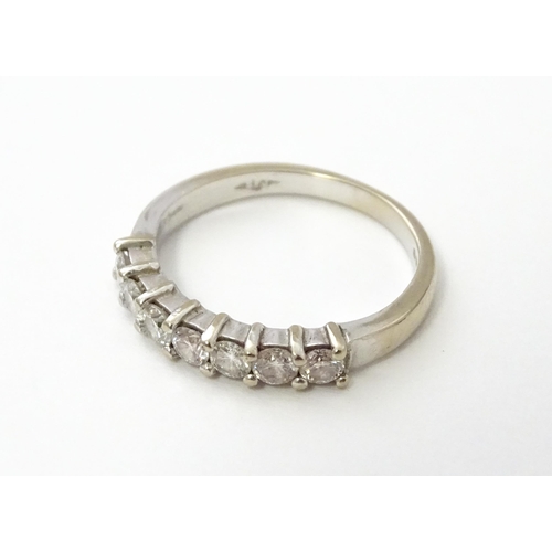 550 - An 18ct white gold half eternity ring set with 7 diamonds. Ring size approx. G