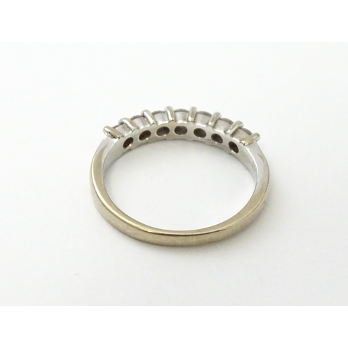 550 - An 18ct white gold half eternity ring set with 7 diamonds. Ring size approx. G