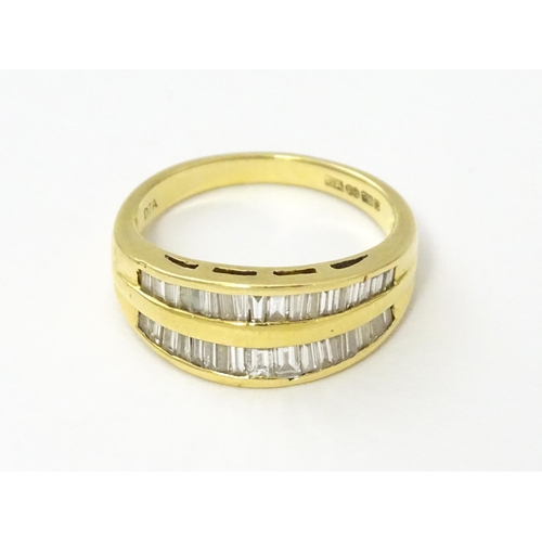 551 - An 18ct gold ring with baguette cut diamonds. Ring size approx. N 1/2