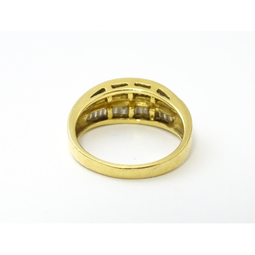 551 - An 18ct gold ring with baguette cut diamonds. Ring size approx. N 1/2