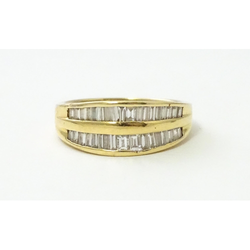 551 - An 18ct gold ring with baguette cut diamonds. Ring size approx. N 1/2