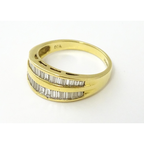 551 - An 18ct gold ring with baguette cut diamonds. Ring size approx. N 1/2