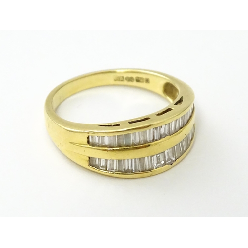 551 - An 18ct gold ring with baguette cut diamonds. Ring size approx. N 1/2