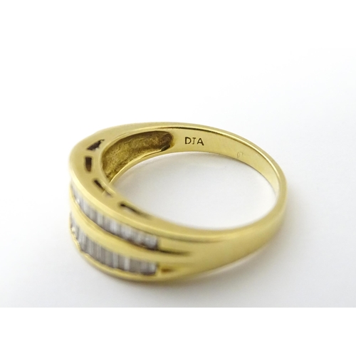 551 - An 18ct gold ring with baguette cut diamonds. Ring size approx. N 1/2