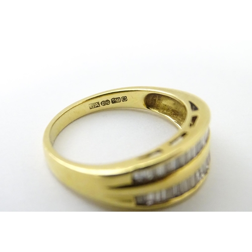 551 - An 18ct gold ring with baguette cut diamonds. Ring size approx. N 1/2