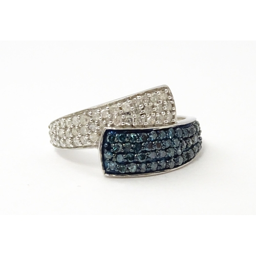 556 - A 9ct white gold ring set with blue and white diamonds. Ring size approx. N