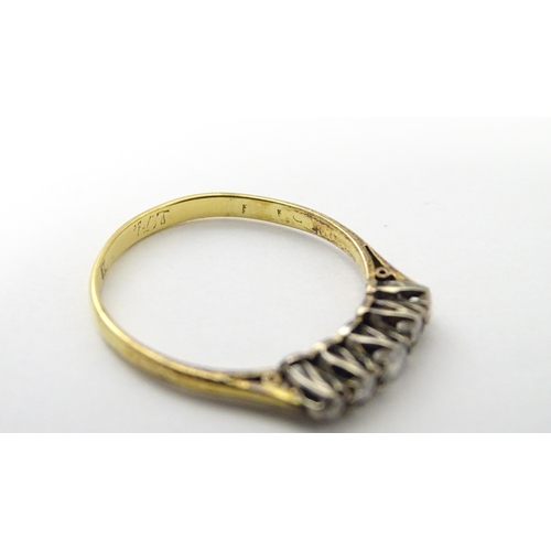 557 - An 18ct gold ring set with five diamonds in a linear setting. Ring size approx. N 1/2