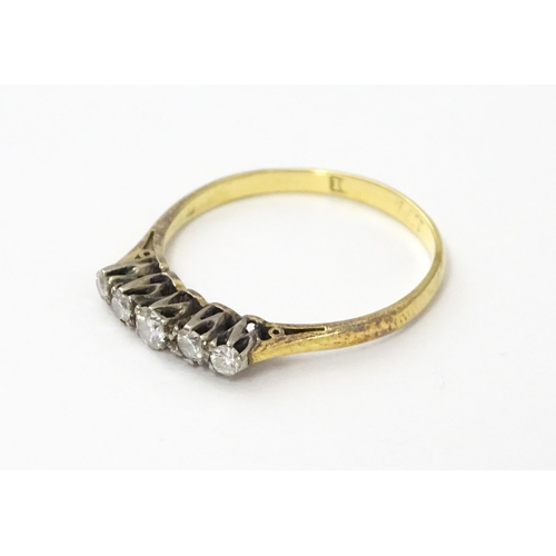 557 - An 18ct gold ring set with five diamonds in a linear setting. Ring size approx. N 1/2