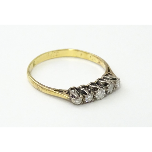 557 - An 18ct gold ring set with five diamonds in a linear setting. Ring size approx. N 1/2