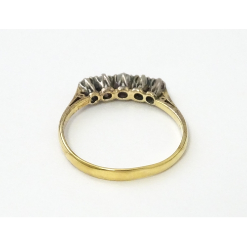 557 - An 18ct gold ring set with five diamonds in a linear setting. Ring size approx. N 1/2