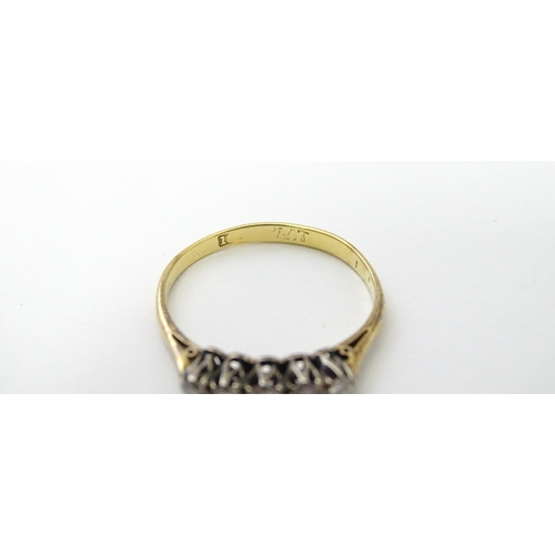 557 - An 18ct gold ring set with five diamonds in a linear setting. Ring size approx. N 1/2