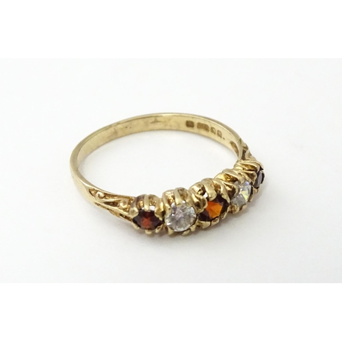 558 - A 9ct gold ring set with red and white stones in a linear setting. Ring size approx. M