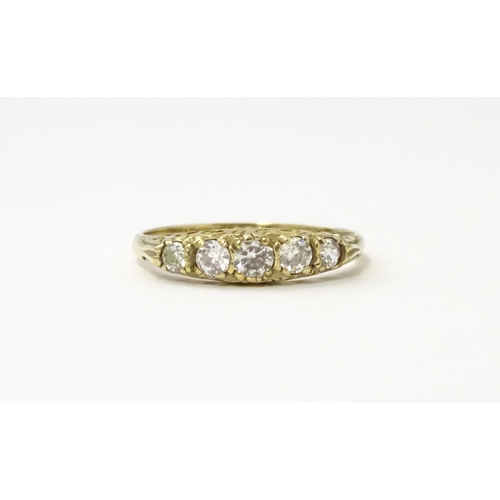 560 - A 9ct gold ring set with five white stones in a linear setting. Ring size approx. O 1/2