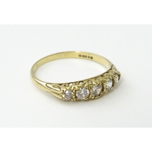 560 - A 9ct gold ring set with five white stones in a linear setting. Ring size approx. O 1/2